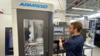 Individual using an ARMROID CNC unit