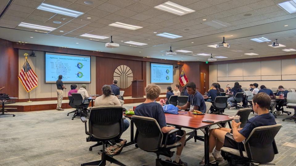 <p>Oglethorpe Power’s George Mathai and Shane Tolbert, Green Power EMC’s distributed energy resources manager, discussing the roles of various generation sources and the benefits of a diverse portfolio with the campers.</p> Oglethorpe Power’s George Mathai and Shane Tolbert, Green Power EMC’s distributed energy resources manager, discussing the roles of various generation sources and the benefits of a diverse portfolio