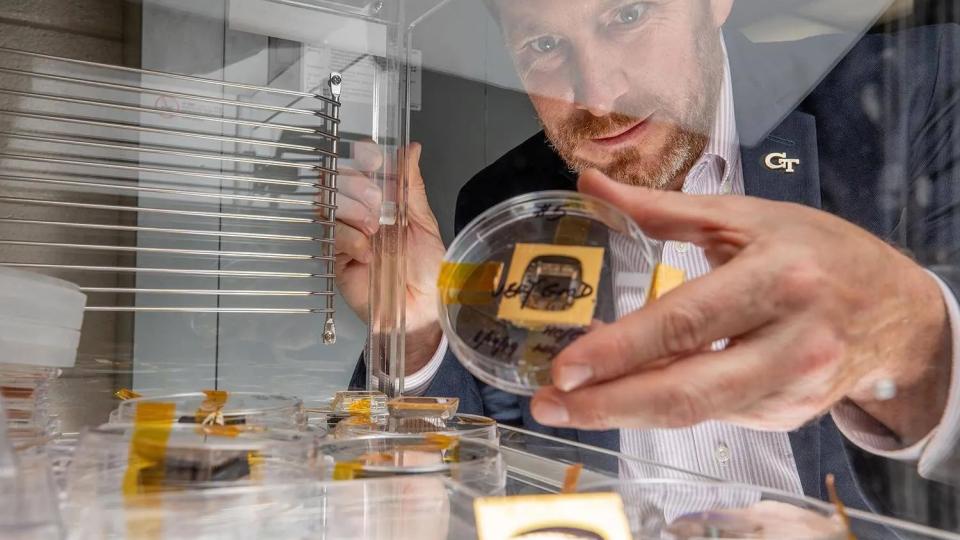 <p>Jud Ready holds a sample of a perovskite solar cell, along with other samples similar to those launched to the International Space Station. (Photo: Branden Camp)</p> Jud Ready holds a sample of a perovskite solar cell, along with other samples similar to those launched to the International Space Station. (Photo: Branden Camp)